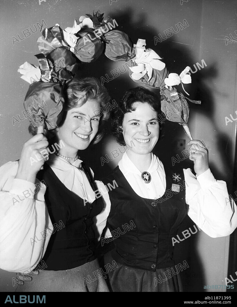 Leaves off the calendar - - Wintry January is temporarily forgotten when Tessa Fenton (left) of Claygate, Surrey and Wendy Stockwell of Farnborough , Kent rehearse a Garland Dance at Cecil Sharp House , Regent's Park Road , London in preparation for the Jubilee Folk Dance and Song Festsival of the English Folk Dance and Song Society . The event takes place at the Royal Albert Hall today and tomorrow. - - 9 January 1958.