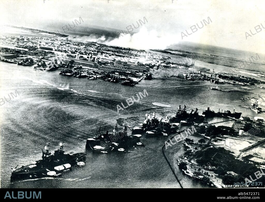 Original caption from a captured Japanese photo 'Thanks to the blessing of heaven and the aid of the gods, the sky opened up suddenly over the Hawaiian Naval Base of Pearl Harbor and below our eyes were ranged in rows the enemy's capital ships... Our Sea Eagles' determined attack had already opened, and a column of water from a direct torpedo hit on a MARYLAND class is rising. On the surface of the water concentric waves are traced by the direct torpedo hits, while murky crude oil flows out. The three bright streaks between the waves are the torpedo tracks. In the distance the conflagration at the Hickam Airfield Hangers is seen.' Released by US Navy.