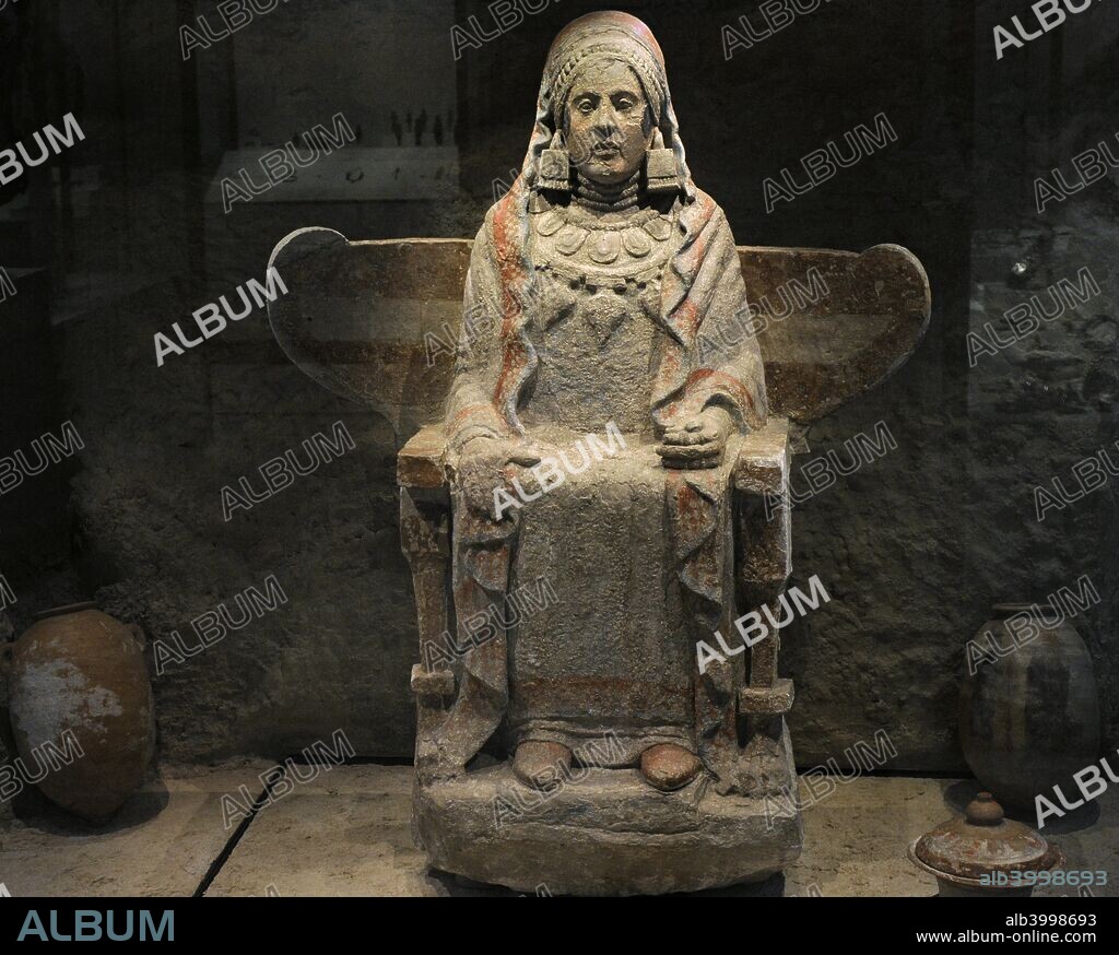 Lady of Baza. Sculpture from the Grave 155 of Baza. Iberian female sculpture sitting on a winged chair and holding a pigeon in her hand. 4th century BC. Polychrome sandstone. Found in the Cerro del Santuario (Basti, Baza, province of Granada, Andalusia, Spain). National Archaeological Museum. Madrid. Spain.