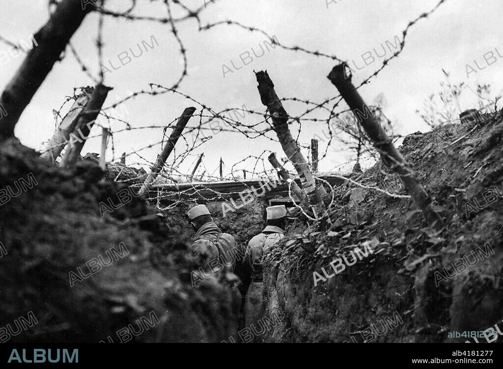 French lookouts posted in a barbed-wire-covered trench. The use of barbed wire in warfare was recent, having only been used for the first time in limited form during the Spanish-American War. All sides in World War I used extensive networks of barbed wire entanglements to prevent ground troops from moving forward. The effectiveness of the wire drove the development of technologies like the tank, and wire-cutting explosive shells set to detonate the instant they made contact with a wire.