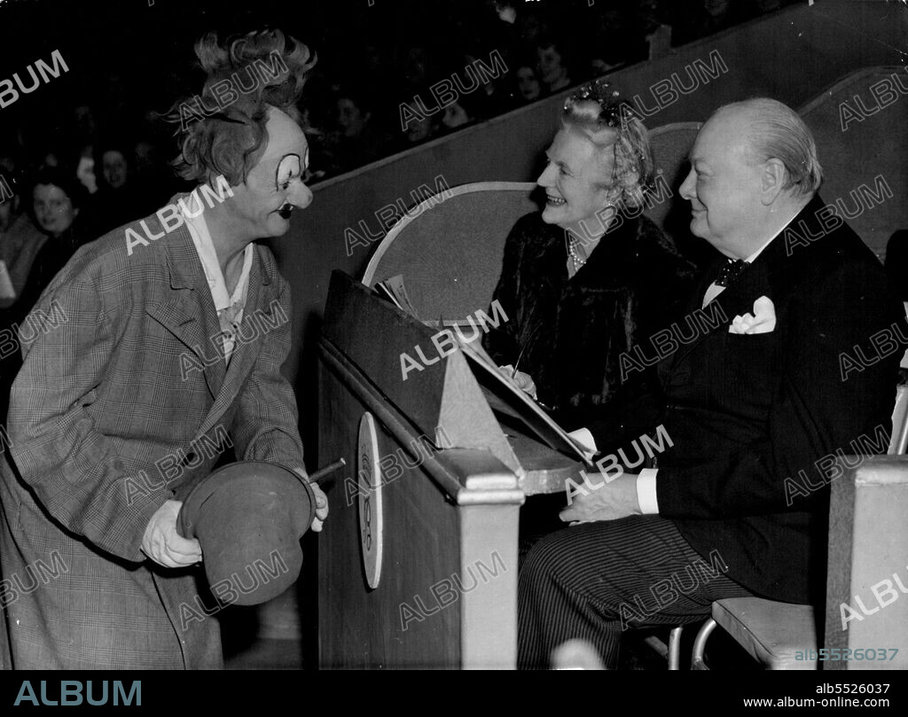 Funny Business For The Churchills : Mr. and Mrs. Winston Churchill enjoy a joke with Coco, a clown in Bertram Mills circus, at Olympia, London last night, December 20. The circus is one of London's big Christmas events, and one of Santa Claus most coveted gifts is a ticket to the show. December 21, 1948. (Photo by Associated Press Photo).