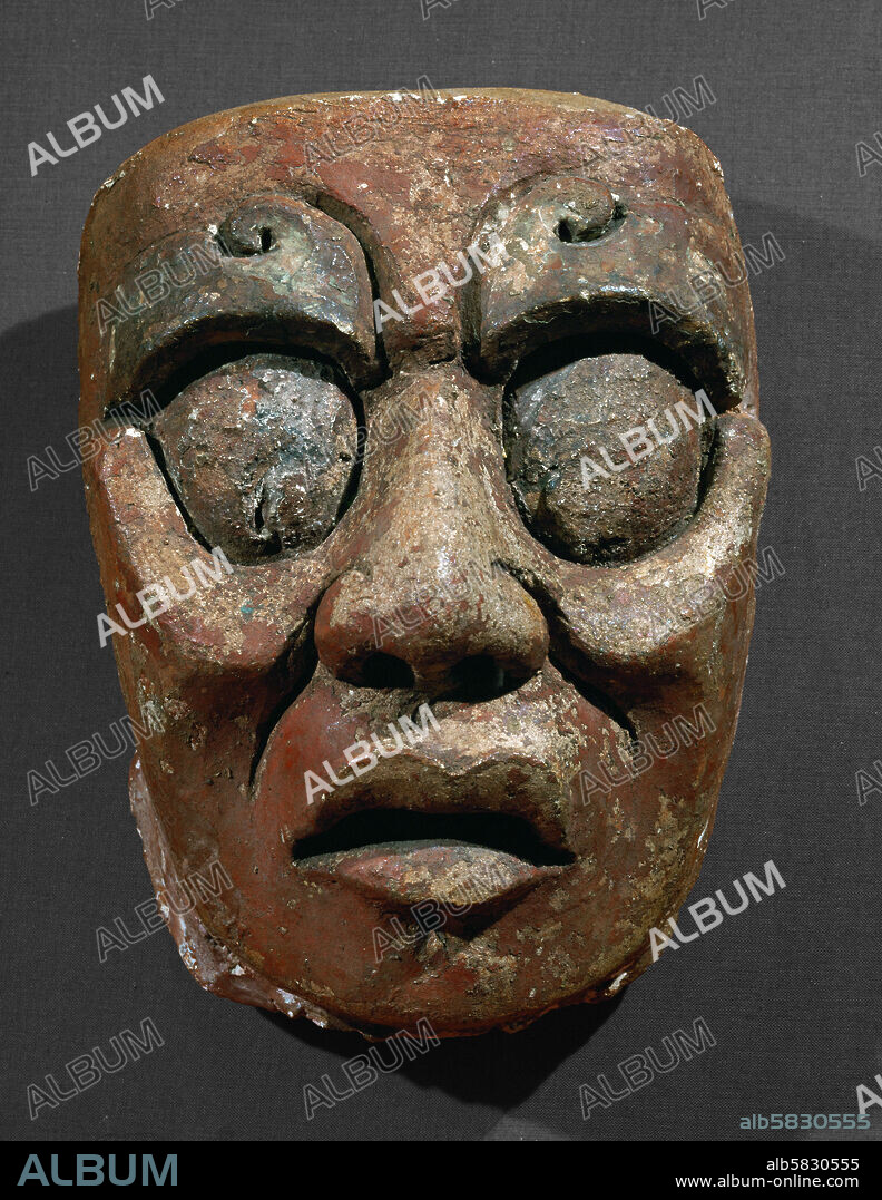Portrait mask of the Sun God from the Sun Temple at Palenque, Mexico. The mask was originally placed on the outer wall of the cella, but was later ritually buried under the temple. Stucco, paint (600-900 CE). Height 21 cm. Inv. 10-222284.