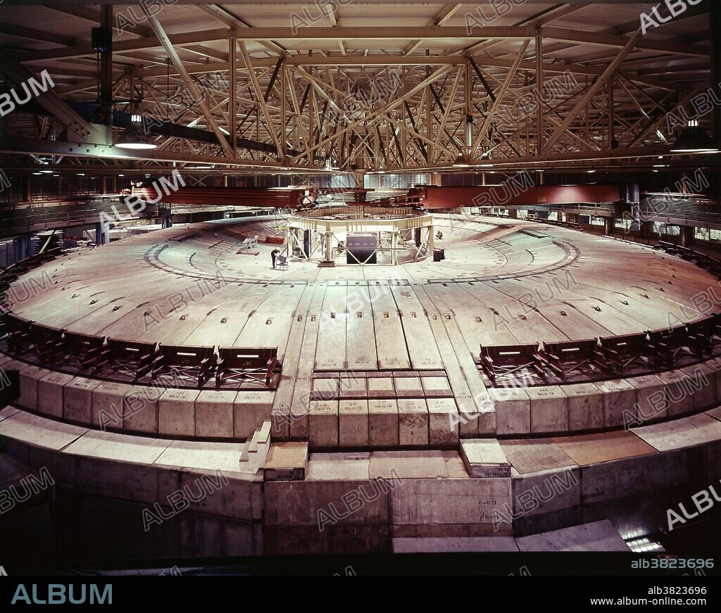 The Bevatron was a particle accelerator at Lawrence Berkeley National Laboratory in California, which began operating in 1954. It was designed to accelerate protons to sufficient energy to create antiprotons, and verify the particle-antiparticle symmetry of nature, then only theorized. The antiproton was discovered there in 1955, resulting in the 1959 Nobel Prize in physics for Emilio SegrÃ¨ and Owen Chamberlain. The Bevatron received a new lease on life in 1971, when it was joined to the SuperHILAC linear accelerator as an injector for heavy ions. The combination was conceived by Albert Ghiorso, who named it the Bevalac. It could accelerate any nuclei in the periodic table to relativistic energies. It was finally decommissioned in 1993.