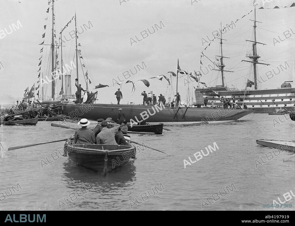 The launch of 'Shamrock IV' at Gosport with H.M.S. Victory in the background, May 1914. 'Shamrock IV' was a yacht owned by Sir Thomas Lipton and designed by Charles Ernest Nicholson. She was the unsuccessful challenger in the 1920 America's Cup.