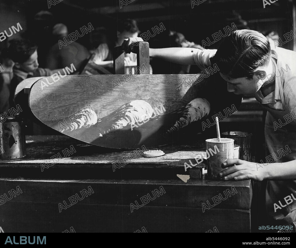 The Schoolboy Toy Makers Of London. Kenneth Wood is painting a rocking boat in a blue and yellow pattern. When the painting is done, the finished toy will leave the Handicraft Centre to join other toys finished at the LCC Middle Row Secondary School for Boys; they are collected at the end of term and distributed to infant schools at the start of the new term. July 28, 1948. (Photo by Camera Press).