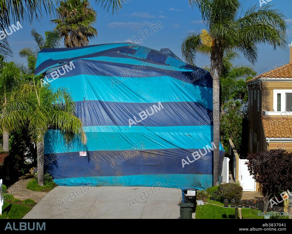 A house in Southern California is wrapped in a gasproof tent and filled with poisonous cyanide gas to kill termite infestation.