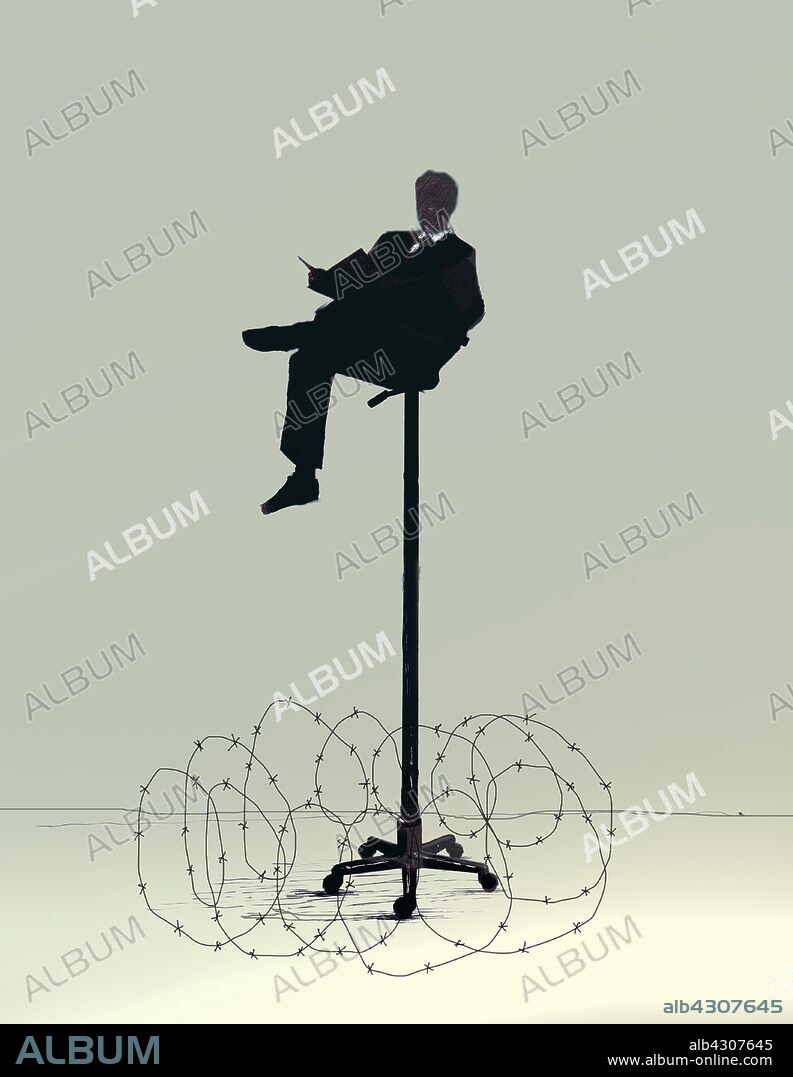 Businessman reading on tall office chair surrounded by barbed wire.