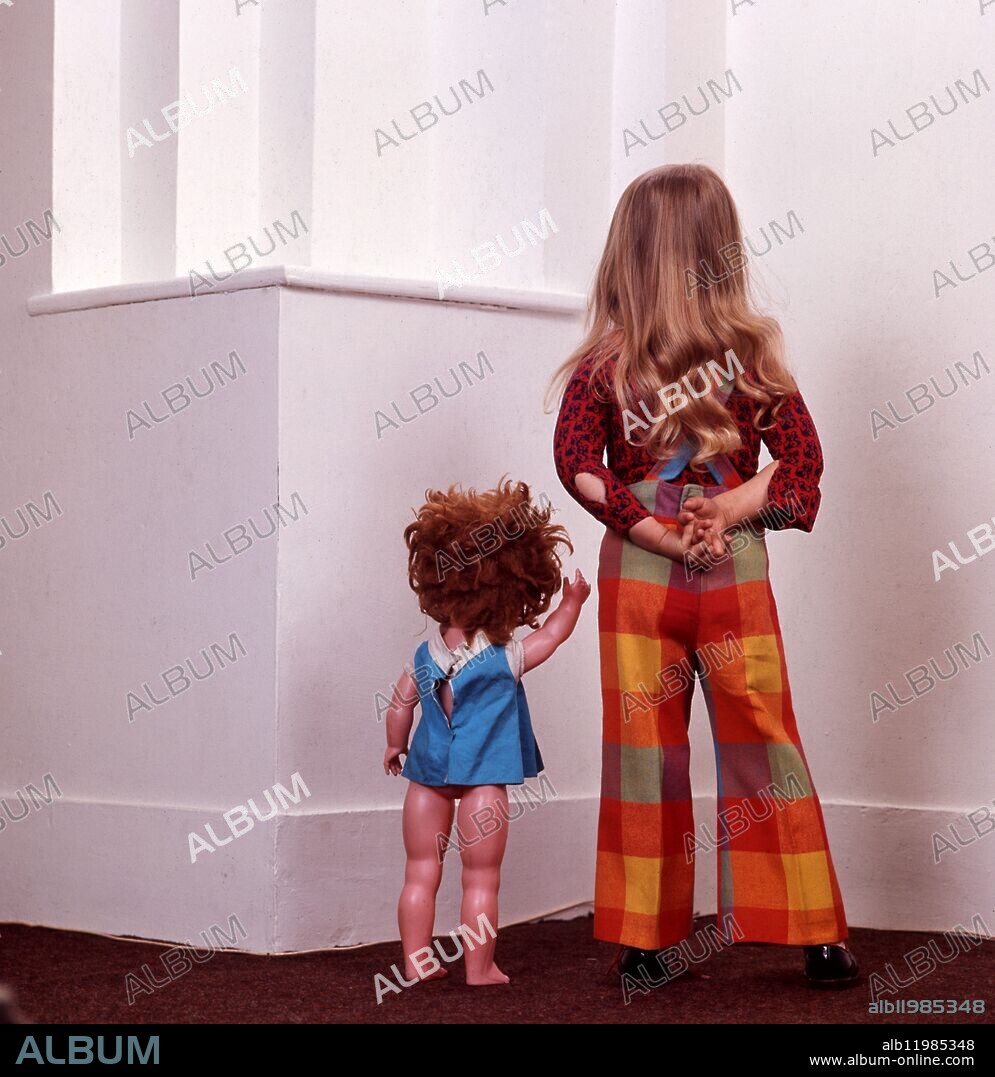 Young girl with her toy doll.