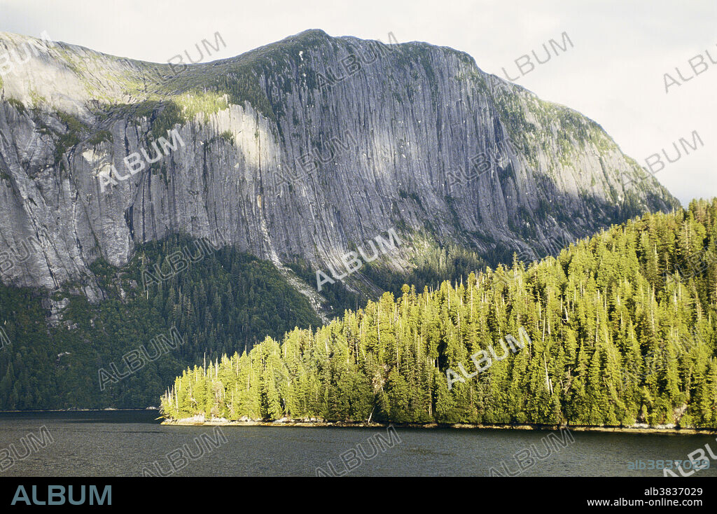 Glacial scouring eroded these sheer walls of rock which measure 3000' straight up from the sea in Misty Fjords National Monument, Alaska. Rocks that were frozen into the glacier were agents of abrasion as the ice carved the valleys.