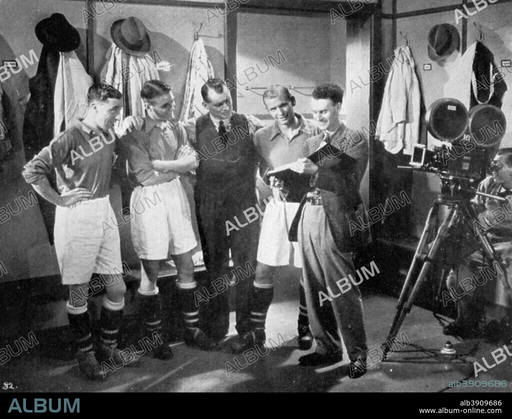 A pause for instruction from film producer Anthony Asquith, Twickenham, London, c1932. During the making of the Gainsborough Pictures film, 'The Lucky Number'. Asquith (1902-1968) (right) with actor Clifford Mollison (1897-1986) (left), and Arsenal footballers Eddie Hapgood (1908-1973), Tom Whittaker (1898-1956) and Cliff Bastin (1912-1991). A print from Football Ambassador by EA (Eddie) Hapgood, Sporting Handbooks LTD, London, 1945.