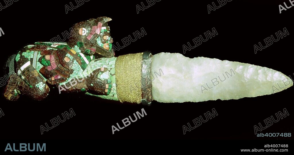 Sacrificial knife, Aztec/Mixtec, Mexico, 15th-16th century. The handle is carved in wood and covered with mosaic of turquoise, shell and malachite. The blade is made of chalcedony. The figure is an eagle warrior, a member of a prestigious order of Aztec warriors. According to myth, the principal god Huitzilopochtli asked the Aztecs to found their city at the place where they saw an eagle perched upon a cactus. This became Tenochtitlan. From the British Museum.