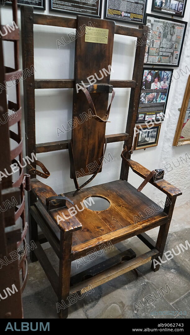 An electric chair known as "Old Smokey" or the "Mot Squat" . The electric chair is a method of execution originating in America in which the condemned person is strapped to a special wooden chair and electrocuted.