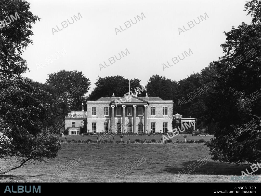 Laverstoke House, Whitchurch, Hampshire, taken from the south in August 1965. Jane Austen's neighbours, the Holders lived here. In the early eighteenth century Henri Portal, the son of a refugee Hugenot family, established a paper-making mill at Laverstoke. In 1727 he secured a contract to manufacture The Bank of England's pound notes. This was mainly due to the beautifully clear chalk-stream waters of the River Test being uniquely suited to making crisp notes. Laverstoke House was designed by Joseph Bonomi and was built for the Portal family in 1780. Now situated in a Grade II listed park of approximately 275 rolling acres which include the upper reaches of the River Test. The original estate comprised in excess of 12,000 acres. However, much of the acreage was sold off in the last century and by 1996 only 500 acres remained with the house. ©TopFoto.