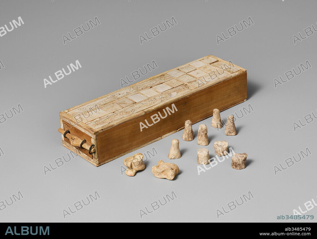 Game Box for Playing Senet and Twenty Squares, Second Intermediate Period–Early New Kingdom, Dynasty 17–Early Dynasty 18, ca. 1635–1458 B.C., From Egypt, Upper Egypt, Thebes, Asasif, Courtyard CC 41, Pit 3, Burial E 3, In coffin, 1915–16, Ivory, copper alloy, modern wood, L. 25 cm (9 13/16 in.); w. 6.7 cm (2 5/8 in.); h. 5 cm (1 15/16 in.), This box has two game boards. The one shown here is for a game called 'twenty squares' or simply 'twenty.' On the opposite side is a board laid out with thirty squares for the game of 'senet.' These were both games in which two players raced each other for position, using knuckle bones as dice to determine each play.