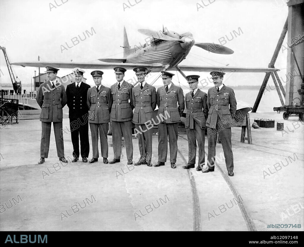 BRITAIN'S SCHNEIDER TROPHY TEAM OUT FOR FIRST TIME TOGETHER AT CALSHOT : Photo Shows: Left to right- Flt.Lt. E.J.L.Hope, Lt.G.L.Brinton R.N., Flt.Lt.F.W.Long, Flt.Lt.G.H.Stainforth, Sqd.Ldr.Orlebar, Lt.J.N.Brothman, Flying Officer L.S.Snaith and Flt.Lt.Dry, line up in front of aircraft. United Kingdom 1931.