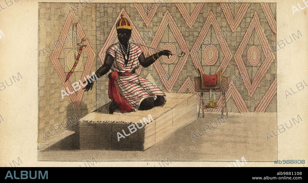 King Sandaineh of Saloum, seated on a couch of reeds, Wolof or Jolof Empire, Senegambia, 18th century. In gold crown, cotton tunic, smoking a tobacco pipe. Scimitar and saddle on the walls. Apartment of the king of Salum. Bour-Salum dans sa case. After Rene Claude Geoffroy de Villeneuves LAfrique, Paris, 1814. Handcoloured stipple copperplate engraving from Frederic Shoberls The World in Miniature: Africa, A description of the manners and customs Moors of the Sahara and of the Negro Nations, R. Ackermann, England, 1821.