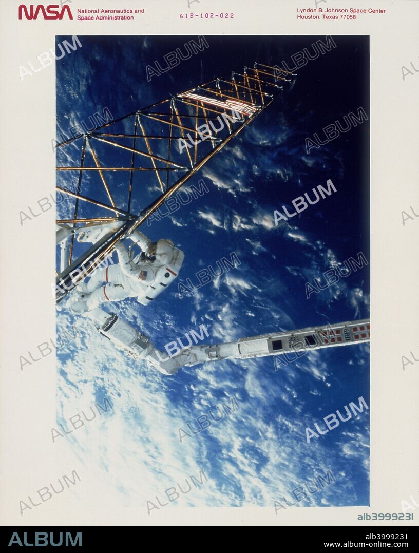 Astronaut on EVA from the Space Shuttle Atlantis, 1985. Astronaut Woody Spring is shown during Extra Vehicular Activity (EVA) from Shuttle Atlantis attached to the robot arm, Remote Manipulator System (RMS), moving a space structure. This is one of the experiments that studied space construction techniques in preparation for the building of the international space station at the beginning of the next century. Space Shuttle Mission 61-B was launched on 26 November 1985 and was the second flight of Atlantis.