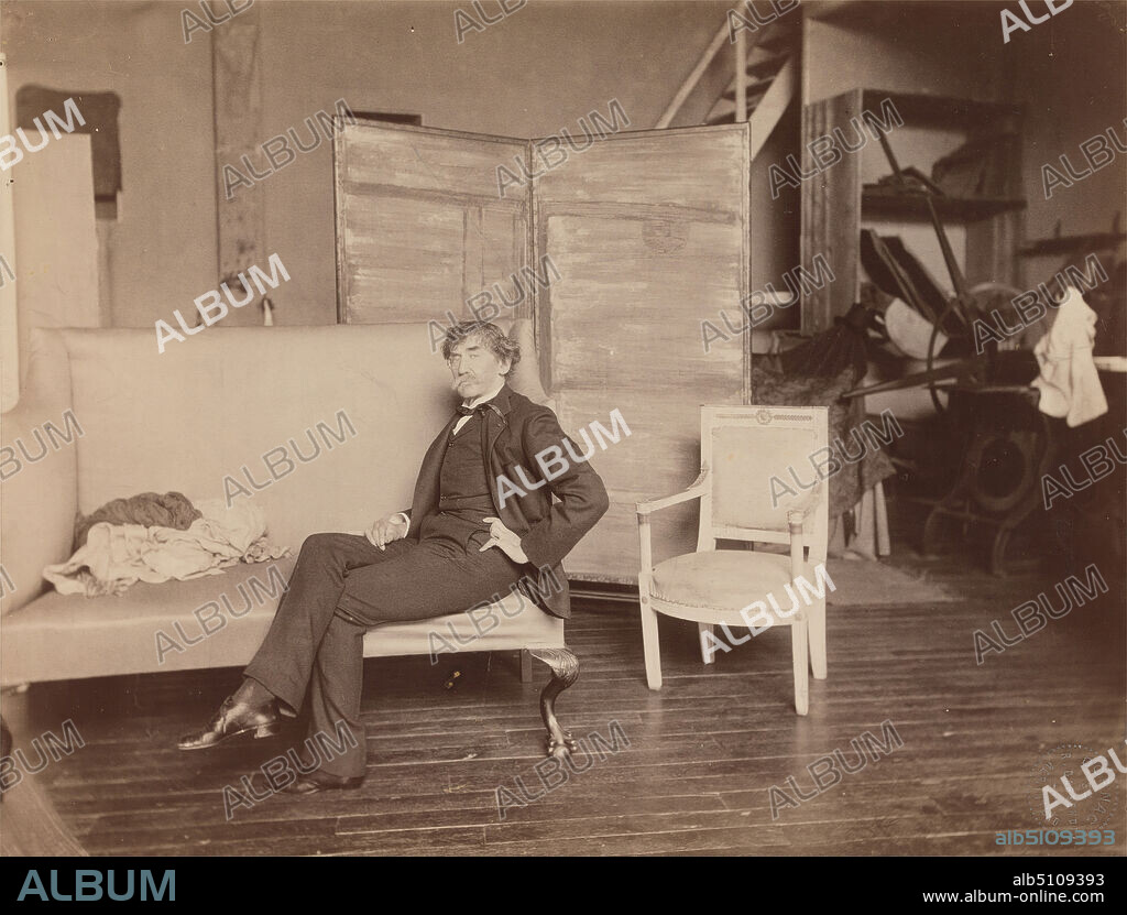 Whistler in his studio on the rue Notre-Dame-des-Champs, Paris, Paul François Arnold Cardon, called 'Dornac', 18591941, French, 1893, Albumen print on thin, smooth, white wove paper, Sheet: 7 3/4 x 10 1/4 inches (19.7 x 26 cm) and Mount: 14 × 17 inches (35.6 × 43.2 cm), artist, blankets, bookcase, bridge (built work), buttons, chair, coat, couch, eyeglasses, floorboards, Japonism, man, monocle, monocle, moon, painter, painting (visual work), portrait, printing press, printmaker, river, screen, screen (furniture), shoes, socks, studio (work space), tie, trousers, vest, Europe, France, Montparnasse, Paris.