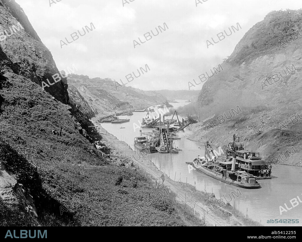 Canal, looking north at Gold Hill, Cucaracha slide, between 1912 and 1914. The Panama Canal is an artificial 82 km (51 mi) waterway in Panama that connects the Atlantic Ocean with the Pacific Ocean. The canal cuts across the Isthmus of Panama and is a conduit for maritime trade. Canal locks are at each end to lift ships up to Gatun Lake, an artificial lake created to reduce the amount of excavation work required for the canal, 26 m (85 ft) above sea level, and then lower the ships at the other end. France began work on the canal in 1881, but stopped due to engineering problems and a high worker mortality rate. The United States took over the project in 1904 and opened the canal on August 15, 1914.
