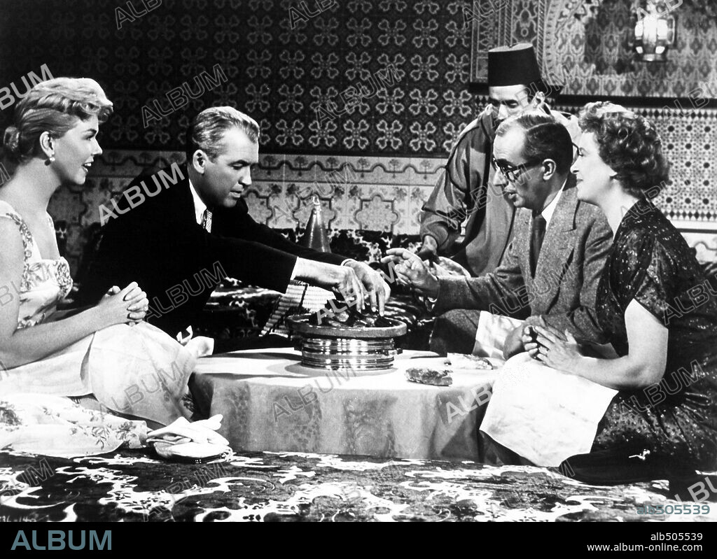 BERNARD MILES, BRENDA DE BANZIE, DORIS DAY and JAMES STEWART in THE MAN WHO KNEW TOO MUCH, 1956, directed by ALFRED HITCHCOCK. Copyright PARAMOUNT PICTURES.