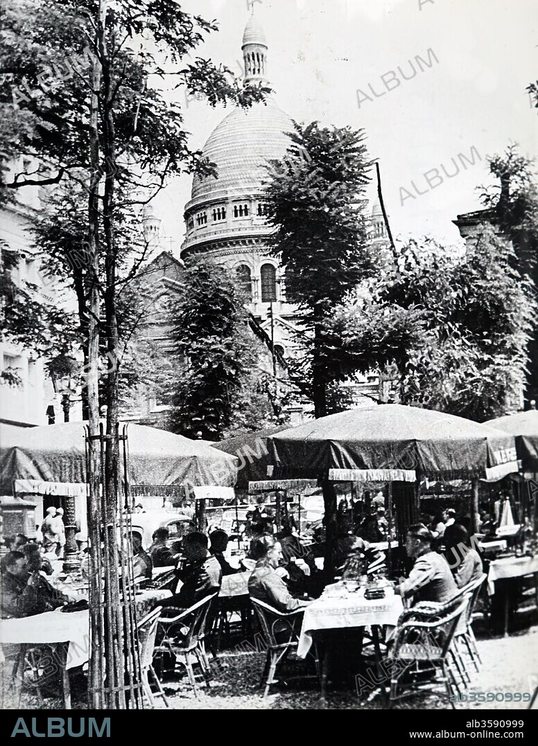 Photograph of German officers relaxing at a cafe in Montmartre near the Sacre Coeur, in Paris, after the Invasion of France in 1940, in World War Two. Dated 20th Century.