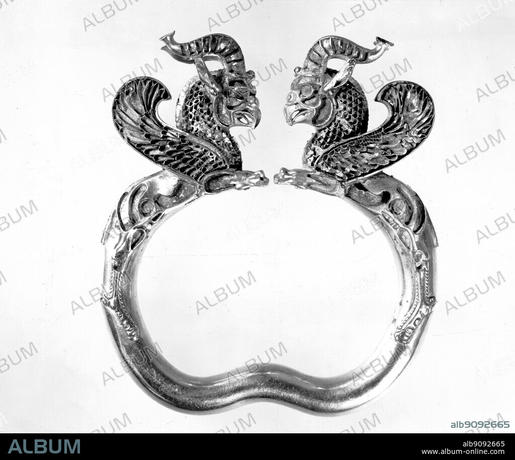 Gold griffin-headed armlet from the Oxus treasure.