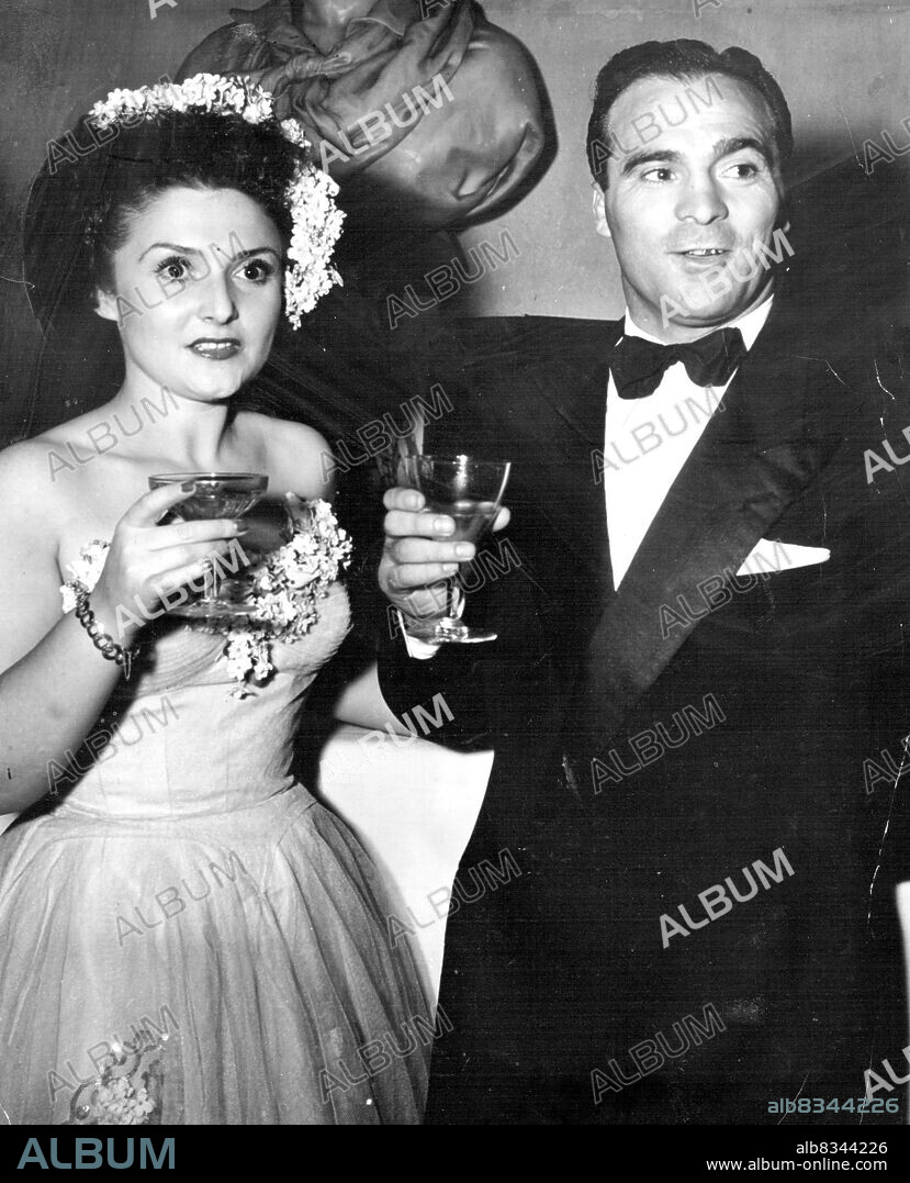 Fistic Royalty. Marcel Cerdan, French Middle weight king, and his lovely wife were ***** those present. January 1, 1948. (Photo by Acme Photo).