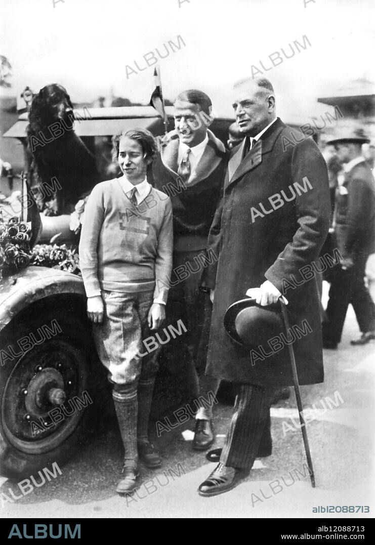 DAUGHTER OF STINNES ENDS WORLD MOTOR TOUR : Fraulein Clarenore Stinnes, daughter of the late German millionaire Hugo Stinnes, and her companion of the tour, Herr Soderstrom, have arrived back in Berlin at the end of their round the world motor tour, which has taken two years. Photo Shows: Fraulein Stinnes and Herr Soderstrom with the German Secretary of State Weisemann (right) on arrival back in Berlin. Germany 1929.