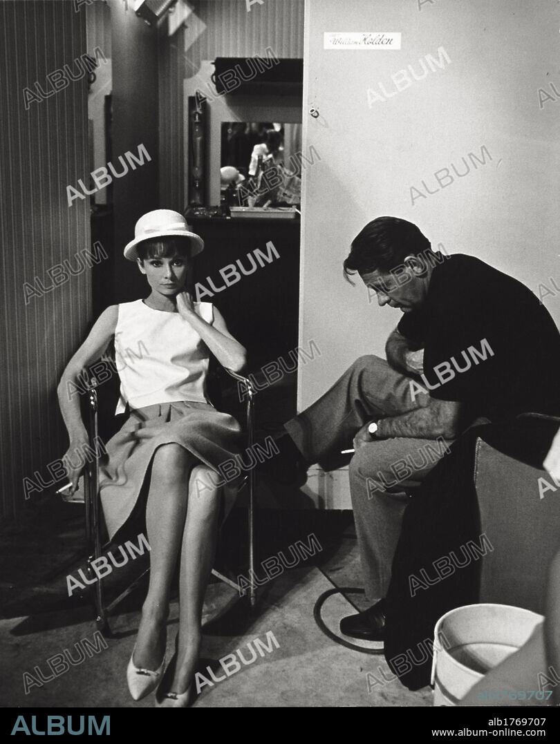 William Holden and Audrey Hepburn. The actors William Holden and Audrey Hepburn in a scene from the film 'Paris When It Sizzles'. France, 1964.