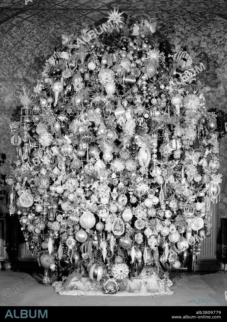 Entitled: "Room with Christmas tree - Harold Lloyd Estate, Beverly Hills, Los Angeles County, CA." A Christmas tree is a decorated tree, usually an evergreen conifer such as spruce, pine, or fir associated with the celebration of Christmas. The tree was traditionally decorated with edibles such as apples, nuts, or other foods. In the 18th century, it began to be illuminated by candles which were ultimately replaced by Christmas lights after the advent of electrification. The Historic American Buildings Survey (HABS) collection is among the largest and most heavily used in the Prints and Photographs Division of the Library of Congress. No date or photographer credited.
