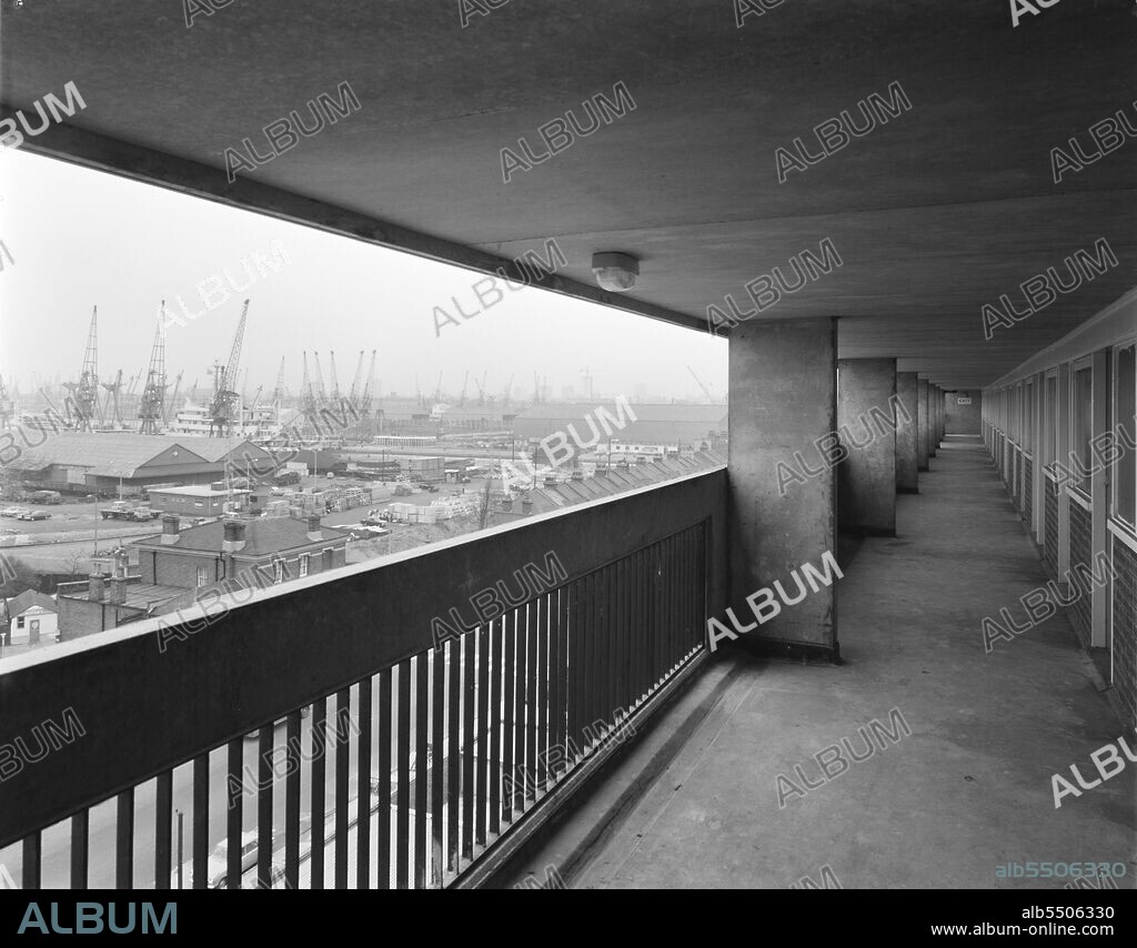 JOHN LAING PLC. Alice Shepherd House, Manchester Road, Isle of Dogs, Tower Hamlets, London, 02/02/1970. A view from an access balcony in a multi-storey block of 'Sectra' flats at Alice Shepherd House, looking towards London's dockland. This 10-storey block of Sectra flats was built by Laing for the London Borough of Tower Hamlets. The contract started in November 1968 and was completed in early 1970 and was referred to by Laing as Satellite 1 due to it being seen as an extension of the contract to build Sectra flats at Lefevre Road. The block was constructed with access balconies, a brick clad lift tower, built in Storiform, and had views over London's dockland.
