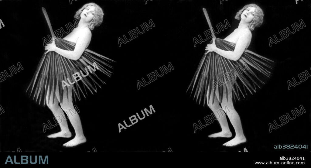 Entitled: "The Palmetto girl" showing a nude young woman holding palmetto frond in front of herself. Stereograph card photographed by Exhibit Supply Company, 1928. RisquÃ© photography is material that is slightly indecent or liable to shock, especially as sexually suggestive. These mildly provocative stereographs were marketed for parlor use in the early 20th century. Used with a stereoscope, the side-by-side images would render in 3D.