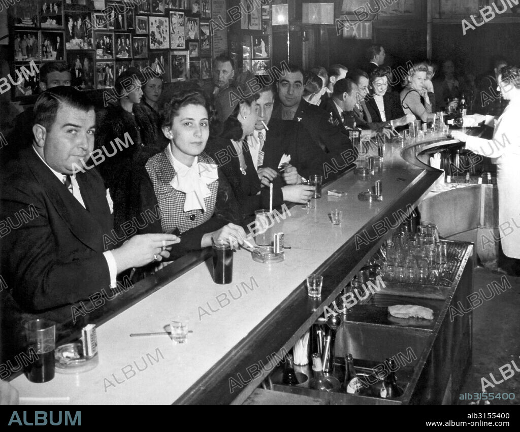 New York, New York:  c. 1945. A crowded and smokey bar scene in the WWII era.