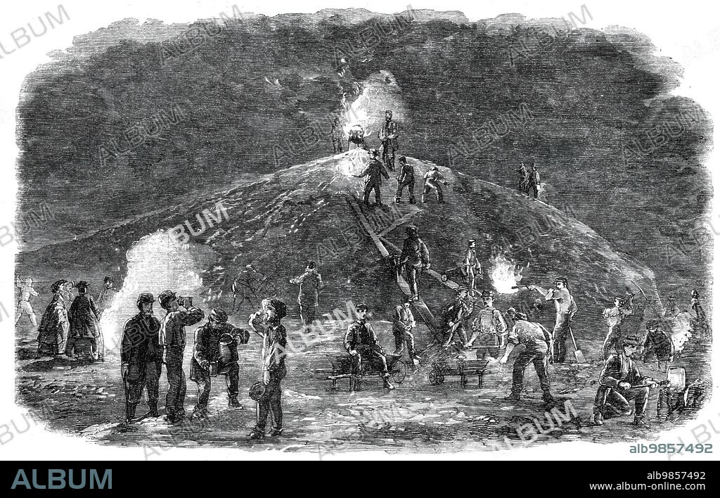 The Deptford Rifle Corps (34th Kent) forming earthworks for their shooting-ground by torchlight, 1860. Volunteer soldiers building a practice-range. '...in order to ensure the safety of the range, it was determined by the corps to increase the height a third more...it was resolved by the members to gain some practical experience of pioneering and fieldwork by constructing the proposed addition themselves...The work thus spiritedly accomplished consists of a principal earthwork (faced with a brick revetment)...and a flank piece (for the protection of a public path passing on that side)...the whole work containing upwards of 500 tons of earth...The accompanying Sketch was taken...when the work was approaching completion, and while the volunteers were labouring, as they have been obliged to do for three-fourths of the time, by the light of lanterns, torches, and coal-fires...The example of self-reliance which has thus been shown by the Deptford company was originally suggested by Captain Allan, of the Royal London Militia, a resident in the neighbourhood, from whose assistance this company has derived much benefit, and who has throughout lent the most valuable aid, with head and hand, in planning and carrying out the fieldwork'. From "Illustrated London News", 1860.