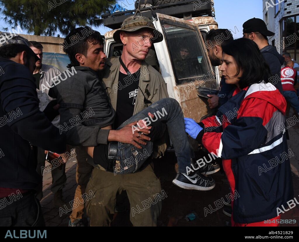 November 2, 2019, Tel Tamir, Syria: DAVE EUBANK carries an injured soldier to a hospital. Eubank, from the humanitarian group Free Burma Rangers stated 'Call it Turkish zone of invasion, zone of genocide, ethnic cleansing,' anything but a safe zone.' From an FBR tweet: 'This zone is one of ethnic cleansing with 300,000 people displaced. Many have been killed and wounded. Homes are destroyed. The Kurds are calling this area 'the genocide zone' The safe zone is not safe by any definition. It is the zone of the Turkish invasion. We've seen their tanks and been fired upon by those tanks and their aircraft. There has been no ceasefire this whole time.' (Credit Image: © Carol Guzy/ZUMA Wire). 02/11/2019