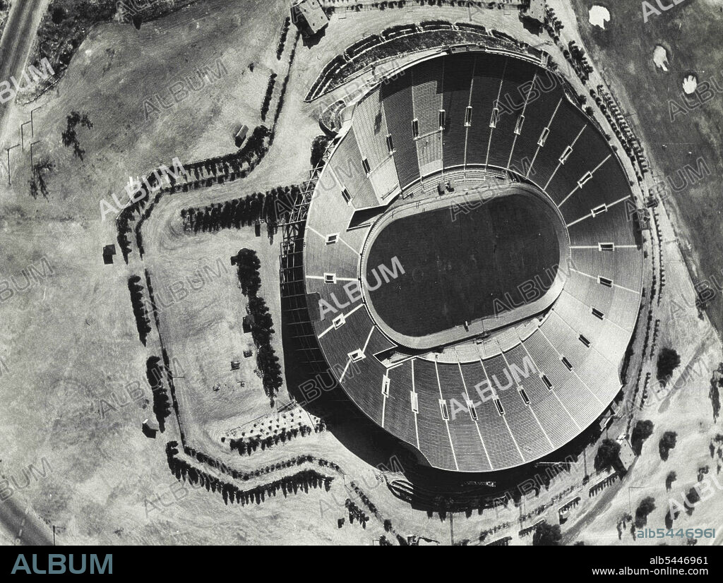 Classic Rose Bowl Turns To Bike Races : This is the Classic Rose Bowl in Pasadana, Calif., where the annual Rose Tournament football contests are decided. Its 86,000 seats will be filled by a far different crowd in August, however, when the cycling races of the Xth Olympiad are staged within the big saucer. The board track, constructed at a cost of $10,000 can be seen surrounding the gridiron. Photo taken from the Gilmore Lion airplane piloted by Colonel Roscoe Turner. July 15, 1932. (Photo by Associated Press Photo).