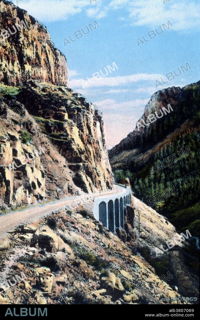 Postcard of Golden Gate photographed by Asahel Curtis, 1928. Golden Gate Canyon is in the northwestern region of Yellowstone NP. The northern portion of the Grand Loop Road traverses the canyon, connecting Mammoth Hot Springs with park features to the south. A road was first built through the Golden Gate in 1884-85, replacing a steep, difficult road over Snow Pass. The work included a wooden trestle where a cliff face precluded grading. In 1900 the viaduct was rebuilt as a concrete structure under the supervision of Captain Hiram M. Chittenden. The viaduct was replaced in turn in 1930-34, the outcome of a program to widen the road. The widened viaduct was itself replaced in 1977. Yellowstone National Park is a national park located primarily in the state of Wyoming, although it also extends into Montana and Idaho.