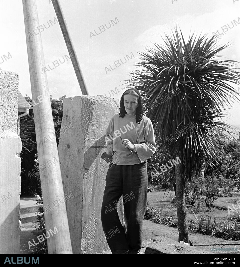 Barbara Hepworth photographed by Peter Keen of Pictorial Press in 1950 . Artist and sculptor Barbara Hepworth outside working, to for the Festival of Britain - Contrapuntal Forms (1951) - Artist copyright: Barbara Hepworth © Bowness - made from Irish blue limestone. 1950 Barbara Hepworth - her studio and garden. She purchased the site in 1949 and lived and worked there for 26 years until her death in a fire on the premises in 1975. Barnoon Hill, St Ives.