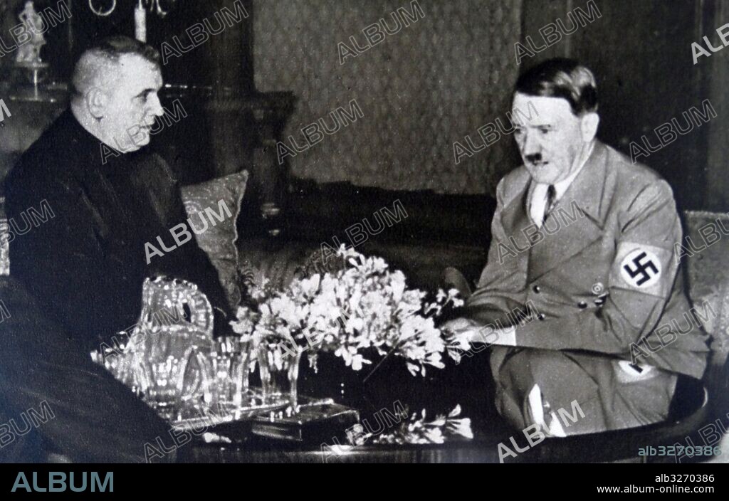 Photographic print of Jozef Tiso (1887-1947) a Slovak Roman Catholic priest, and a leading politician of the Slovak People's Party, meeting with Adolf Hitler (1889-1945) a German politician, leader of the Nazi Party, Chancellor of Germany, and Fuhrer of Nazi Germany. Dated 20th Century.