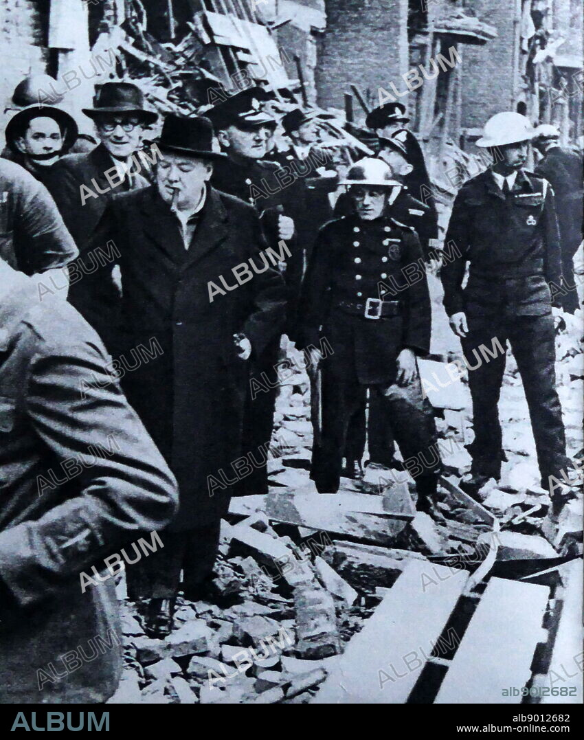 Photograph of Sir Winston Churchill walking amongst the rubble of homes as a result of an air raid on London. Sir Winston Leonard Spencer-Churchill (1874-1965) a British politician and Prime Minister of the United Kingdom. Dated 20th Century.