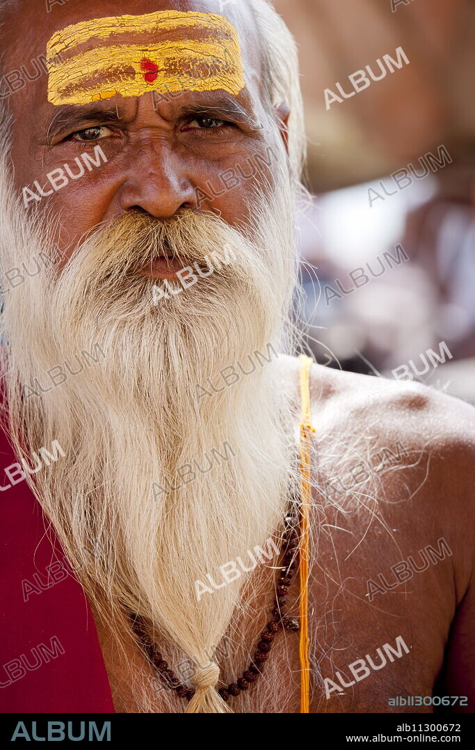 Hindu Sadhu holy man with traditional markings of symbol of Shiva in street in holy city of Varanasi, Benares, Northern India.