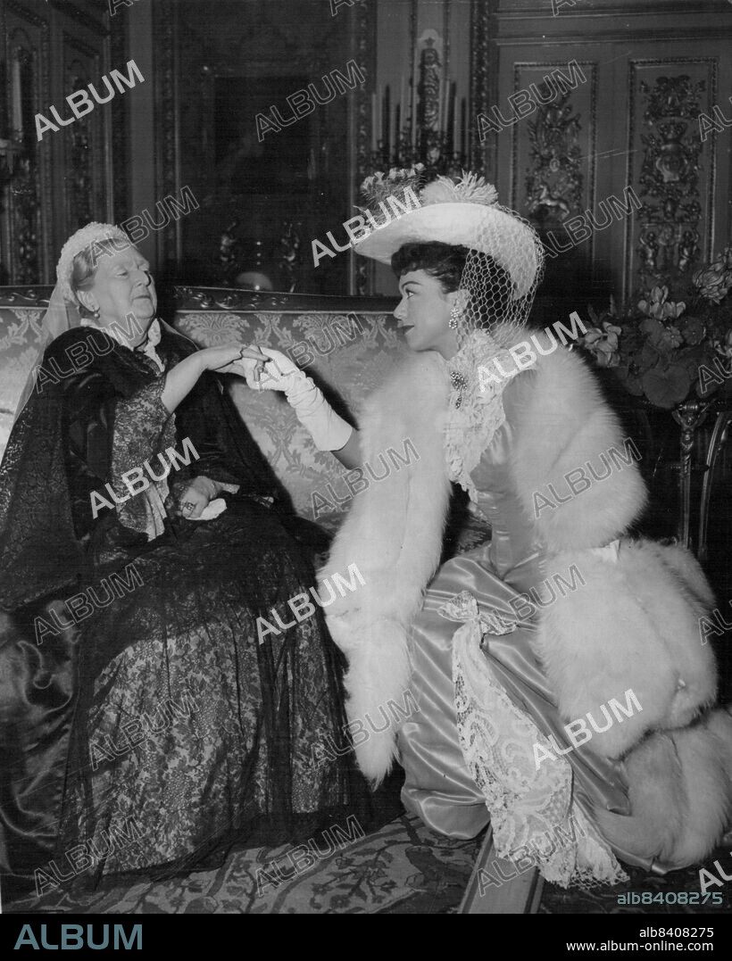 "Queen Victoria Receives Melba"Queen Victoria, played by Dame Sybil Thorndike, receives Dame Nellie Melba, the world famous soprano, played and sung by Patrice Munsel, in the Red Drawing Room at Windsor Castle.This scene from the British colour film "Melba" was made at the Nettlefold Studios, Walton-on-Thames, Surrey.For the scene, a replica of the red drawing room was built in the studios from details given by Librarian at Windsor Castle.Dame Sybil Thorndike is the sixth actress to play the part of the historic "old queen"- the others have been Pamela Stanely, Anna Neagle, Irene Dunn, Rene Asherson and Murial Aked. November 13, 1952. (Photo by Associated Press Photo).