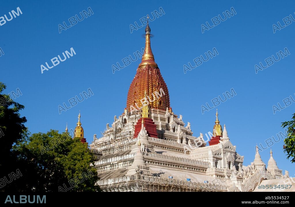 Perhaps the highest revered temple in Bagan, the Ananda Pagoda was built in 1105 CE during the reign of King Kyanzittha (1084–1113) of the Bagan Dynasty. It is one of four surviving original temples of Bagan (also called Pagan). The temple layout is in a cruciform with several terraces leading to a small pagoda at the top covered by an umbrella (‘hti’). The Buddhist temple houses four standing Buddhas—facing east, north, west and south. The temple is said to be an architectural wonder in a fusion of Mon and adopted Indian styles of architecture. It was damaged in the earthquake of 1975. However, it has been fully restored and is well maintained by frequent painting and whitewashing of the walls. On the occasion of the 900th anniversary of its construction celebrated in 1990 the temple spires were gilded. Bagan, formerly Pagan, was mainly built between the 11th century and 13th century. Formally titled Arimaddanapura or Arimaddana (the City of the Enemy Crusher) and also known as Tambadipa (the Land of Copper) or Tassadessa (the Parched Land), it was the capital of several ancient kingdoms in Burma.