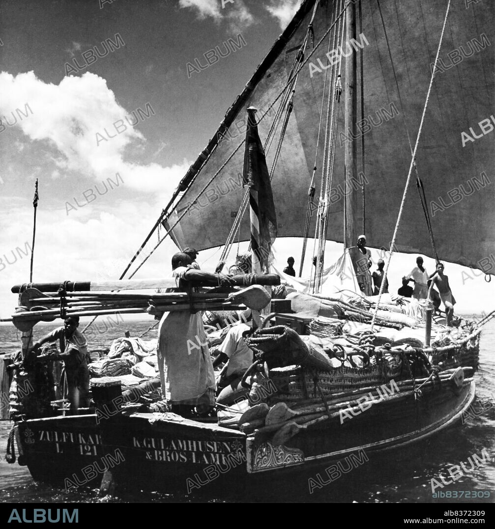 A dhow is a traditional Arab sailing vessel with one or more lateen sails. It is primarily used to carry heavy items, like fruit, along the coasts of the Arabian Peninsula, Pakistan, India and East Africa. Larger dhows have crews of approximately thirty people, while smaller dhows typically have crews of around twelve.<br/><br/>. Even down to the present day, dhows make commercial journeys between the Arab or Persian Gulf and East Africa using sails as their only means of propulsion. Their cargo is mostly dates and fish to East Africa and mangrove timber to the lands of the Persian Gulf. They often sail south with the monsoon in winter or early spring, and back again to Arabia in late spring or early summer.<br/><br/>. The term 'dhow' is also applied to small, traditionally-constructed vessels used for trade in the Red Sea and the Persian Gulf area and the Indian Ocean from Madagascar to the Bay of Bengal. Such vessels typically weigh 300 to 500 tons, and have a long, thin hull design.<br/><br/>. Dhow also refers to a family of early Arab ships that used the lateen sail, the latter of which the Portuguese likely based their designs for the caravel (known to Arabs as sambuk, boom, baggala, ghanja and zaruq).