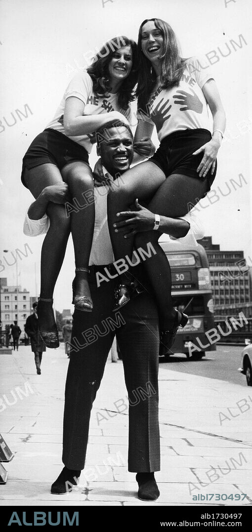 November 7, 2011 - Boxer 'Smokin' Joe Frazier has died after a battle with liver cancer. Joseph William 'Joe' Frazier (January 12, 1944 Ð November 7, 2011). Frazier was a former Olympic and Undisputed World Heavyweight boxing champion, whose professional career lasted from 1965 to 1976, with a brief comeback in 1981. In 1970, Frazier defeated Ali on points in the highly anticipated 'Fight of the Century' in 1971. The International Boxing Research Organization (IBRO) rates Frazier among the ten greatest heavyweights of all time. PICTURED: FILE - London, England, U.K. - 'Smokin' Joe' Frazier Holds girls on his shoulders. (Credit Image: © KEYSTONE Pictures USA/ZUMAPRESS.com). 08/05/1960