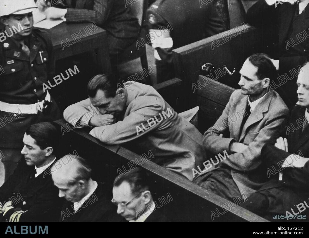 Nuremberg Trials Open -- A picture of despair - Goering, biting his nails, leans forward in the Dock and appears to take no interest in the proceedings. January 17, 1946. (Photo by Acme).