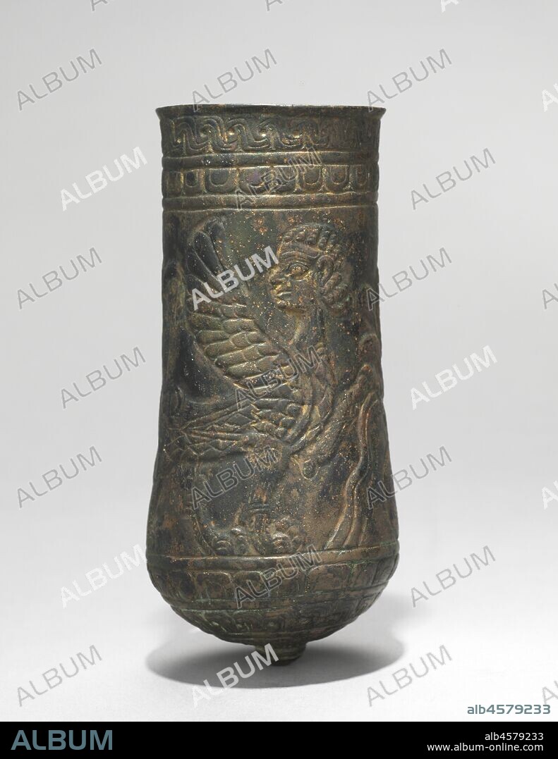 Button-Based Situlas, 900-700 BC. The metalworkers of Luristan provided the Assyrian empire with elaborate bronze ornaments and vessels. These two situla are decorated symmetrically---one with ibexes drinking from an overflowing water jar; the other, with sphinxes.