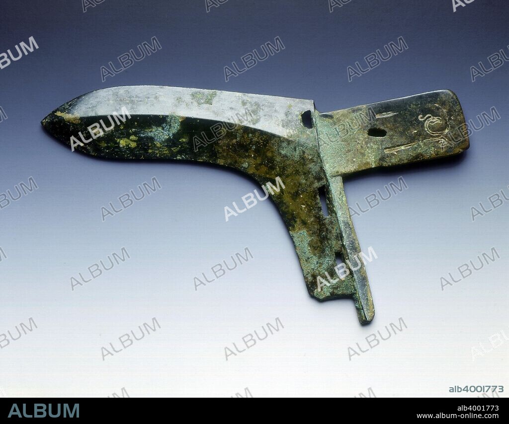 Bronze ge, Spring and Autumn period, Eastern Zhou dynasty, China, 5th century BC. A bronze ge with good patination. The horizontal flange is incised with stylised phoenixes on both sides. The halberd has rectangular holes adjacent to the vertical flange.