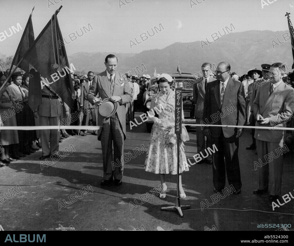 Princess Margaret cuts tape opening Princess Margaret highway in Trinidad Feb.4. At left is Gov. Sir Hubert Rance. February 06, 1955. (Photo by Associated Press Photo).