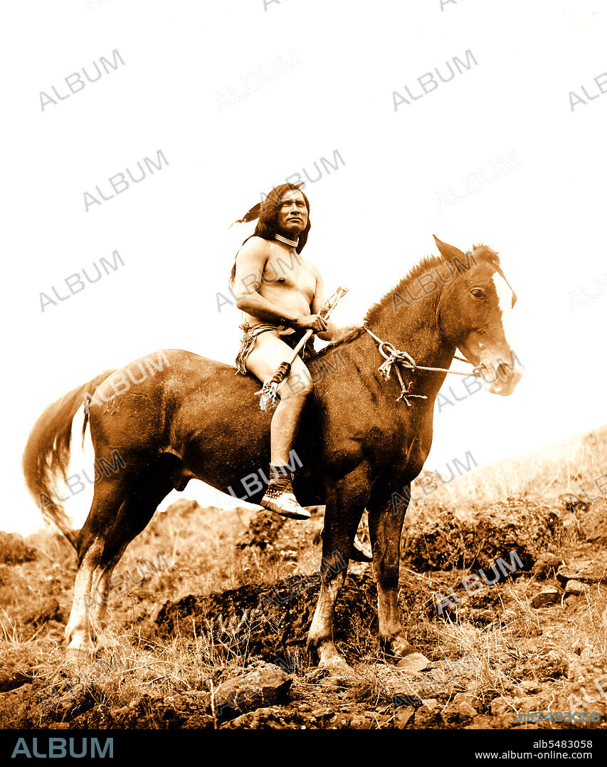 Edward S. Curits Native American Indians - Nez Percé man, wearing loin cloth and moccasins, on horseback circa 1910.